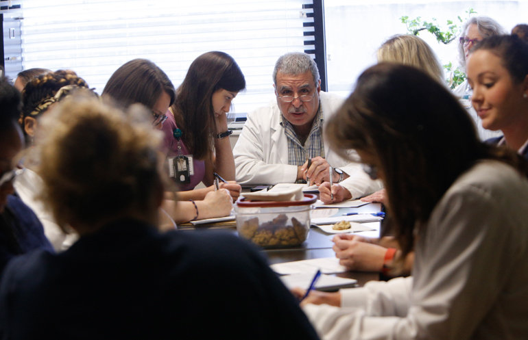 A team of medical professionals  gather for a daily meeting to discuss the elderly patients at the “Acute Care for Elders” unit at the University of Alabama Hospital, Birmingham. (Hal Yeager for KHN)